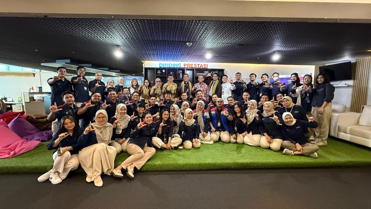 Corporate engagement gathering at PGN achievement wall